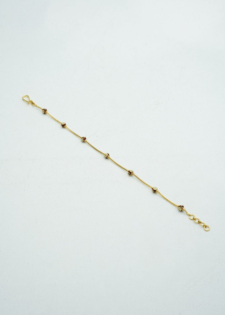 Delicate gold bracelet with coloured stones