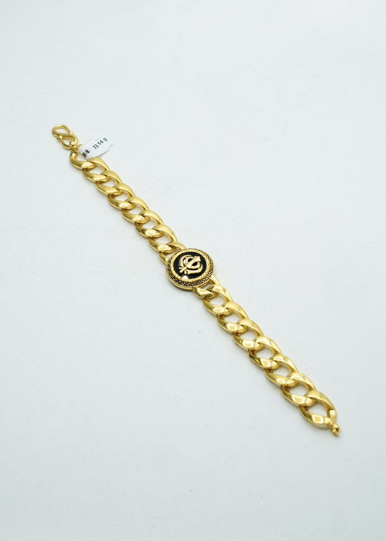 Designer yellow gold Curb & Cuban bracelet with black insignia at the center