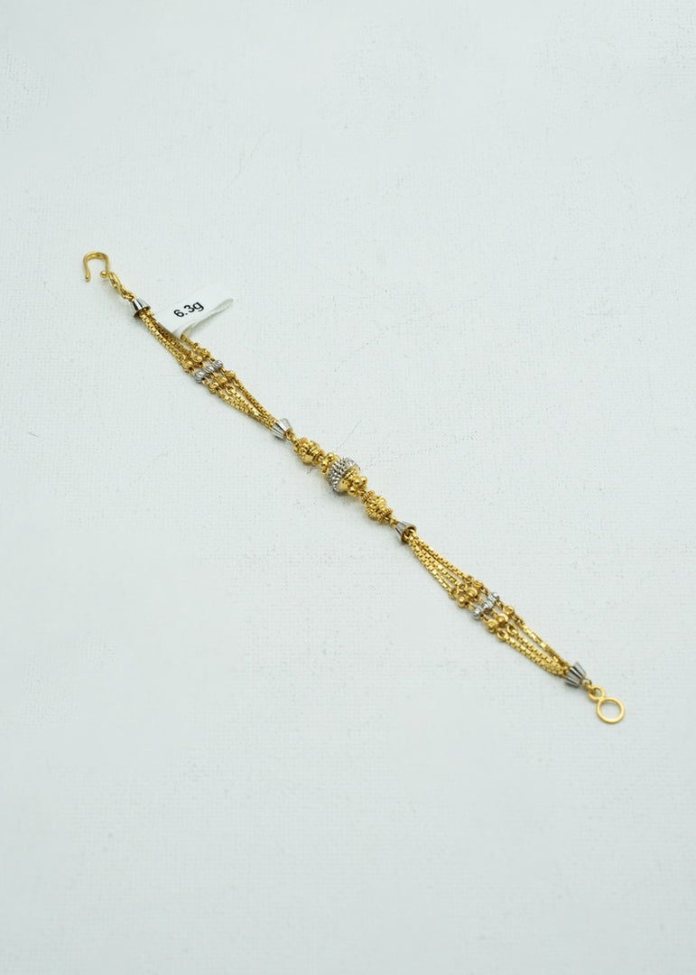 Dual-toned white and yellow gold ethnic bracelet