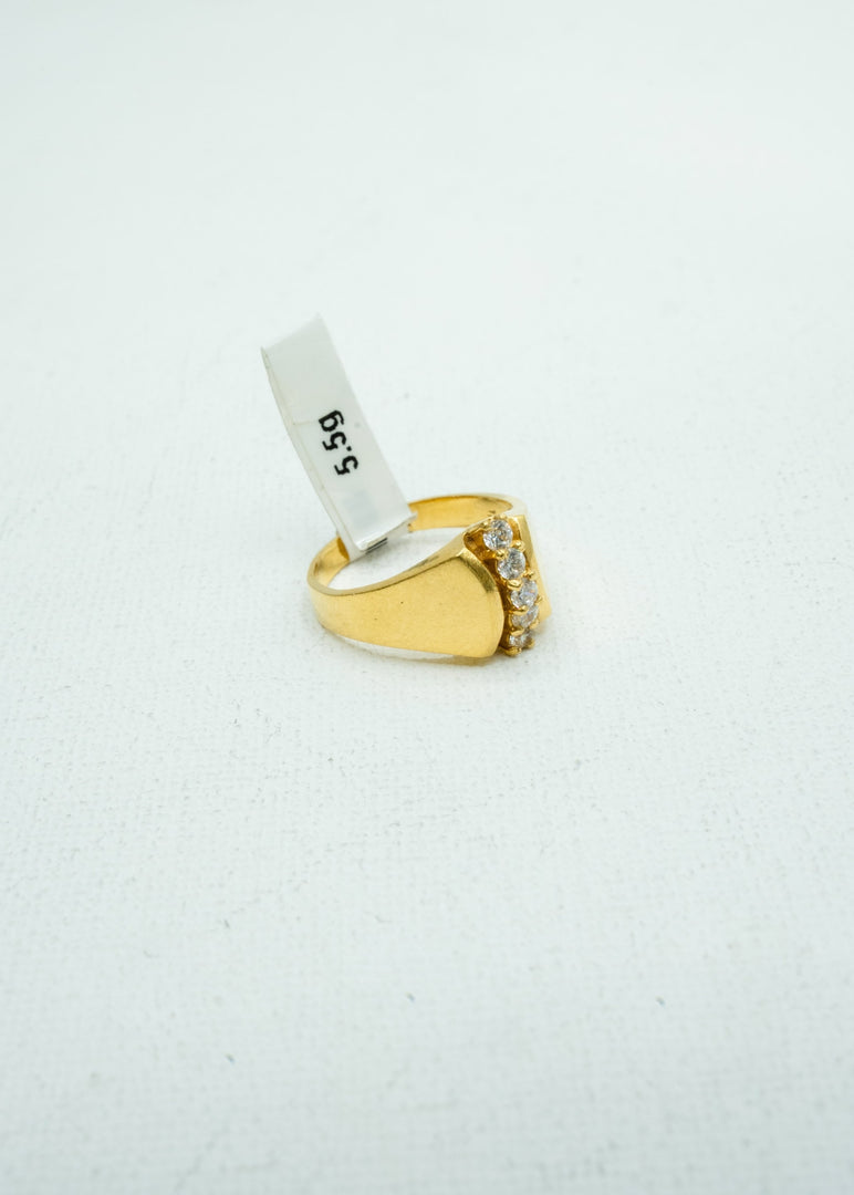 Gold ring with single line of diamond studs at the center
