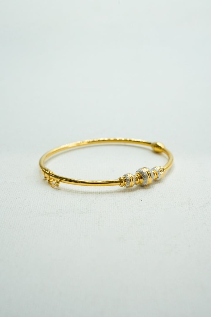 Two-toned yellow and white gold bangle bracelet