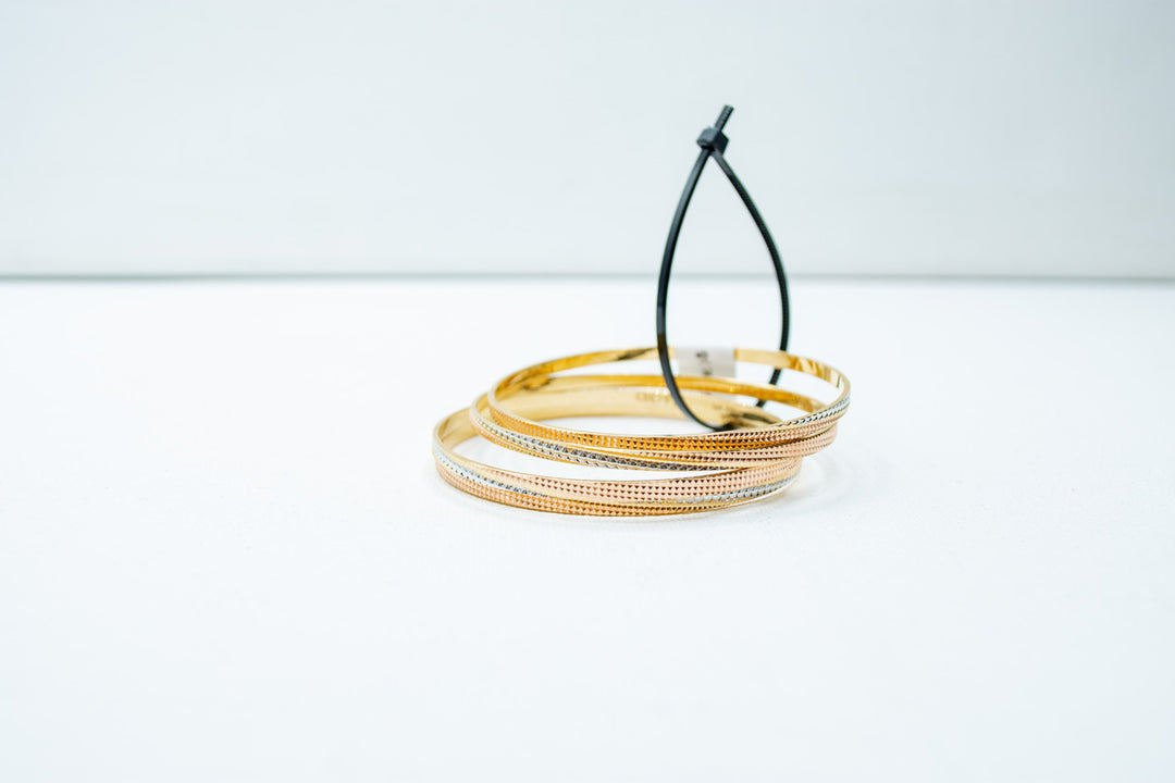 Slim two-toned ethnic gold bangles set
