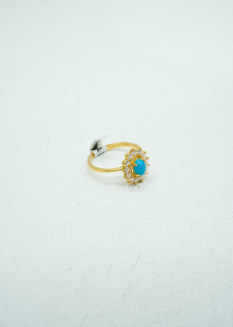 Dainty diamond studded flower with a turquoise colour stone center gold ring