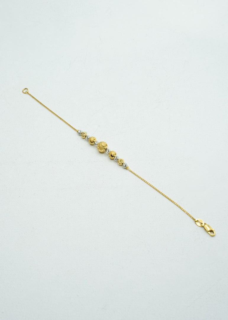 Delicate looking white and yellow gold beaded bracelet