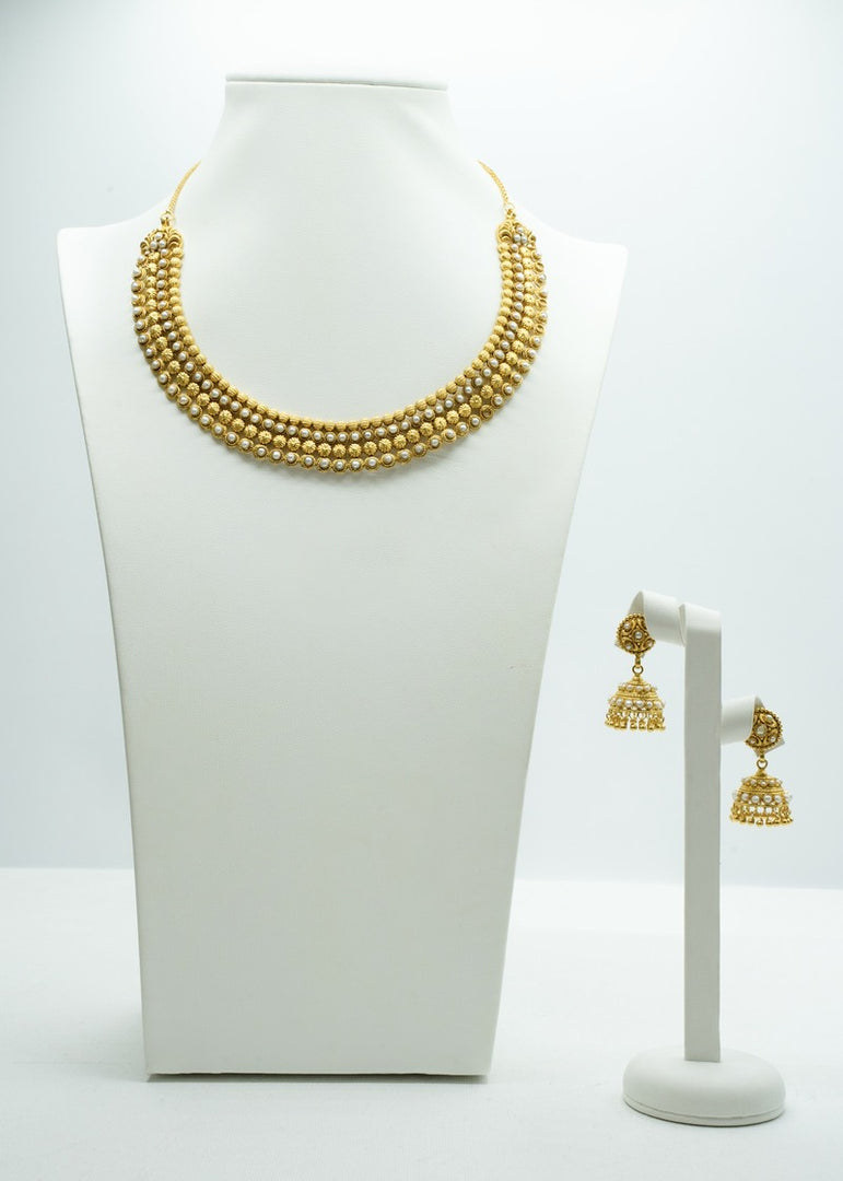 Ethnic gold beaded necklace paired with Gold jhumki set