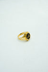 Hexagon-shaped black stone signet ring in gold with carvings on the band