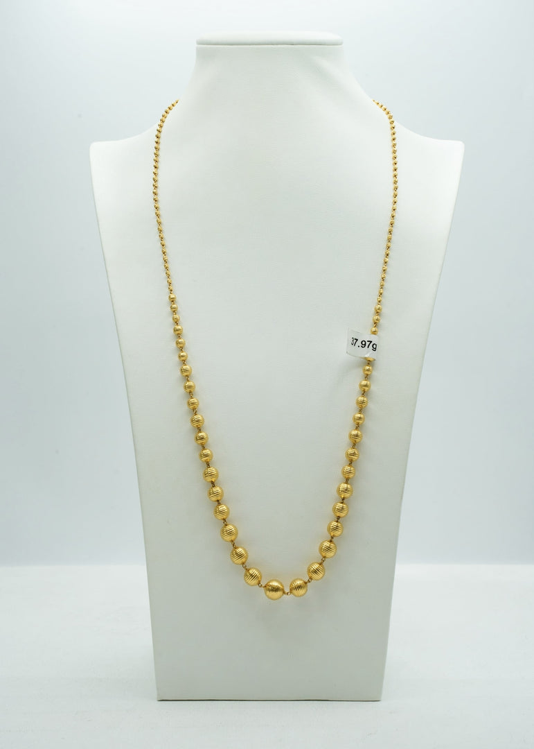 Long bright yellow gold beaded chain