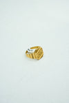 Modern gold ring with understated carvings