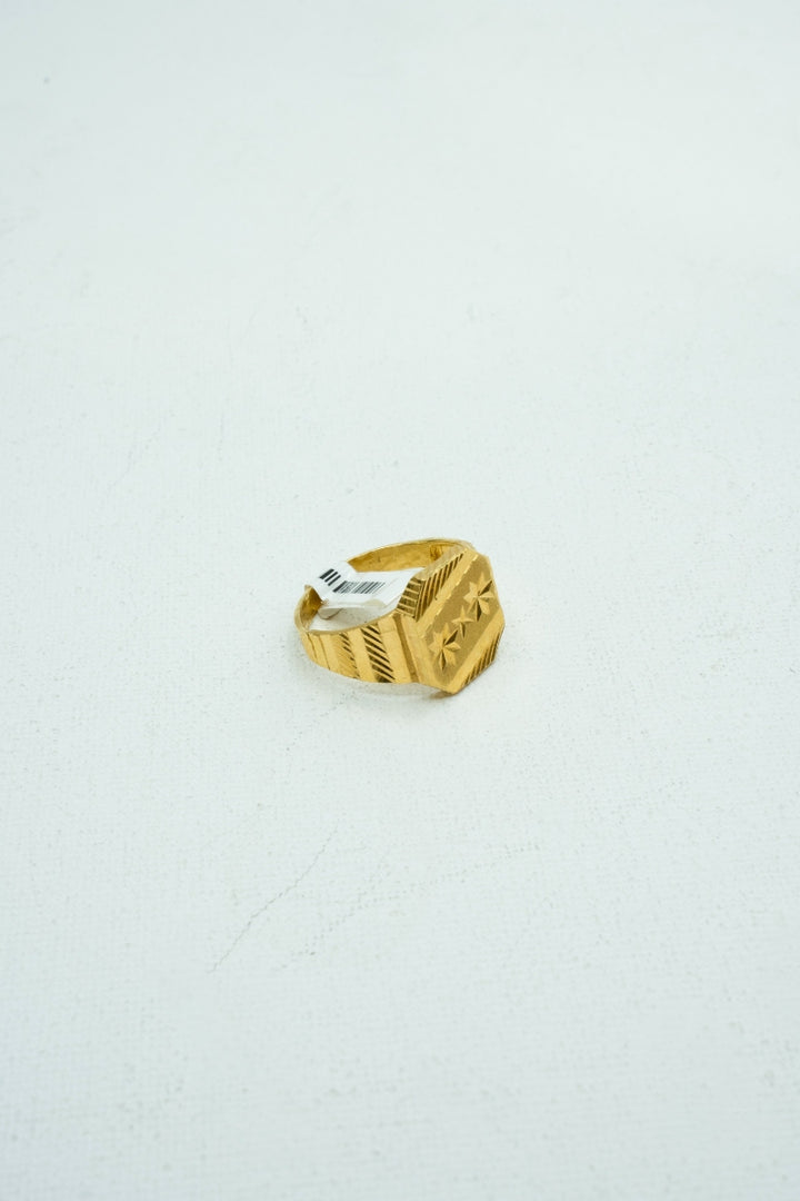 Modern gold ring with understated carvings