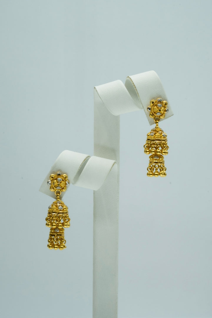 Sunburst two-toned yellow and white gold traditional jhumka earrings with beautiful carvings