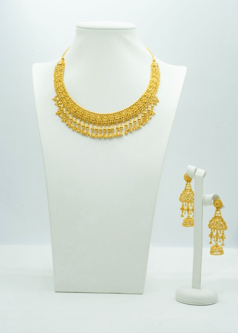 Traditional heavy Gold neckpiece with intricate carvings and matching heavy gold drop earrings