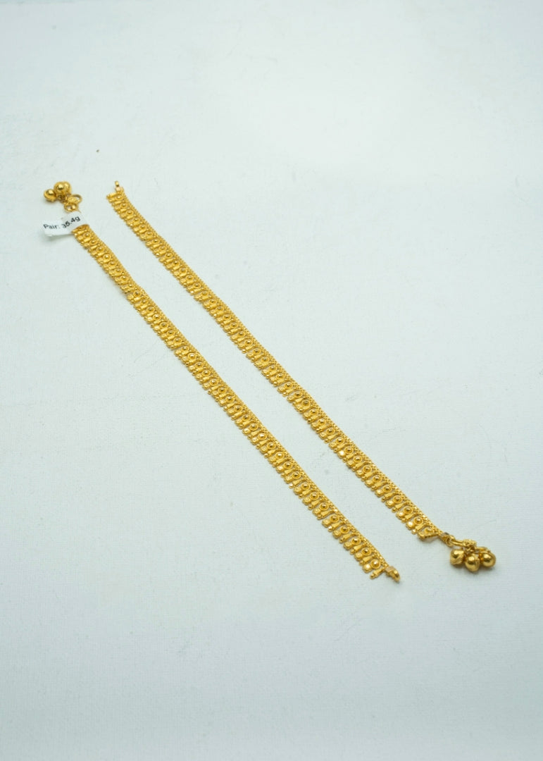 Traditional yellow-gold pair of ankelets with intricate design
