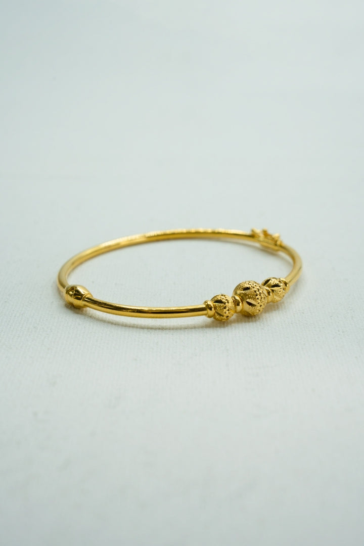 Understated yellow gold beaded bangle bracelet