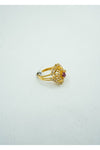 Yellow gold ring with diamond crusts and jaali work with a coloured stone center.