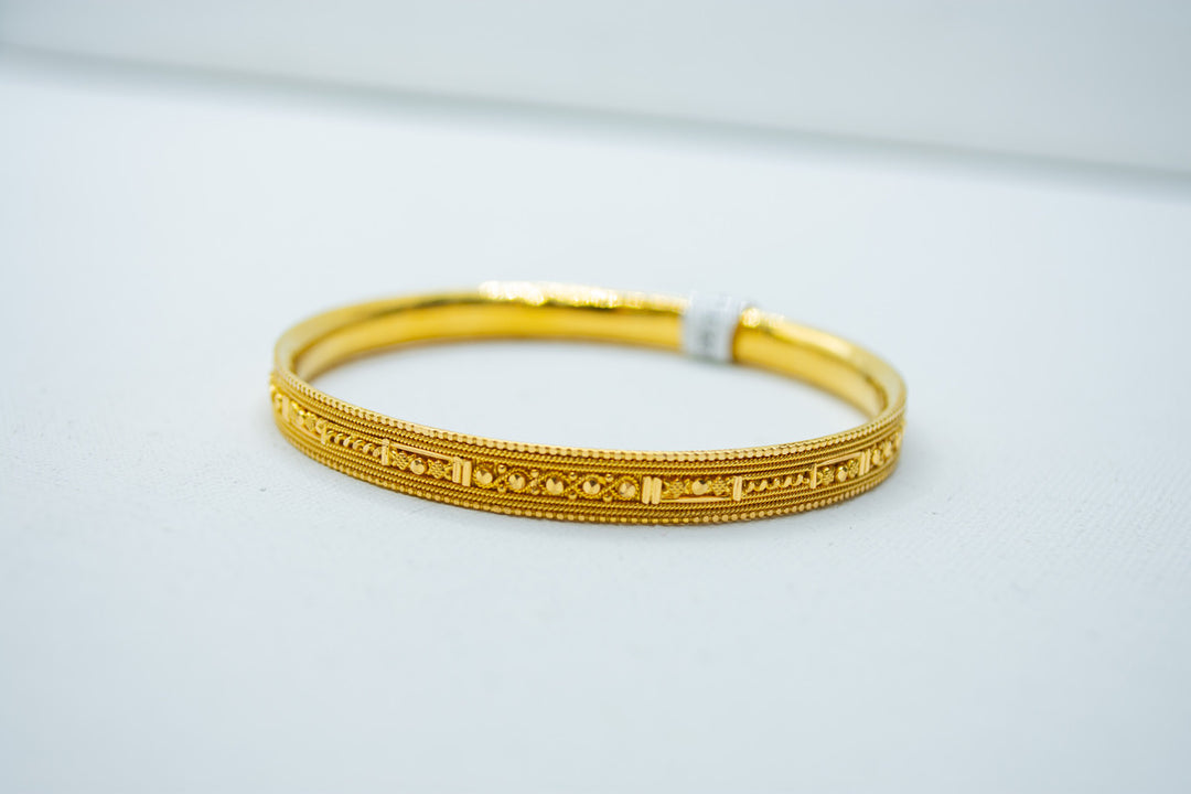 Intricate designer gold bracelet