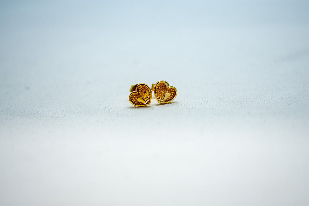 Heart-shaped gold stud earrings